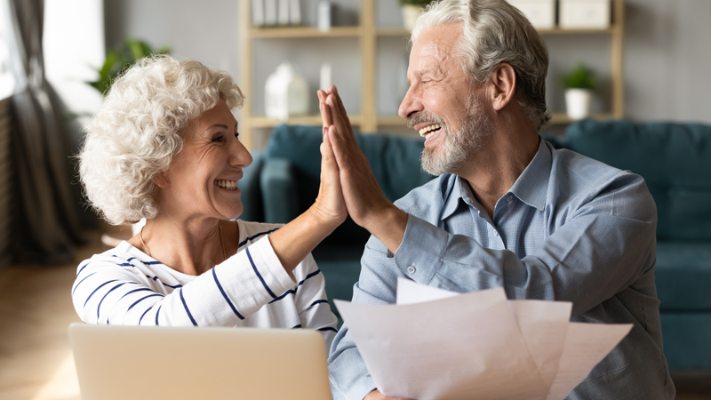 Retired couple high fiving