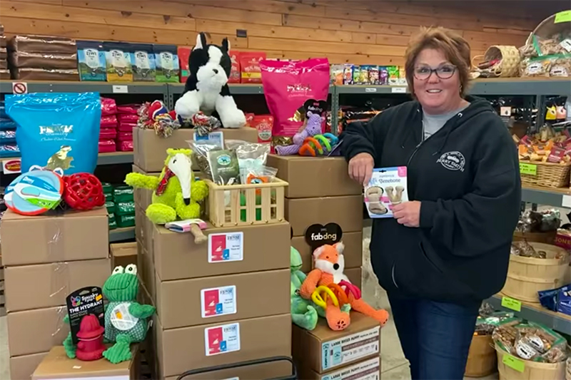 Amy Smith with Puppy Kits at Feed and Seed Station