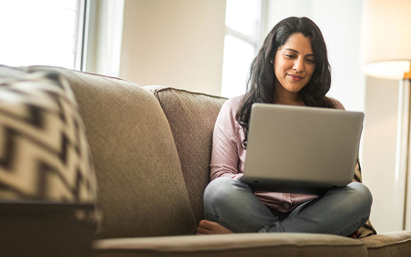 Woman on couch with laptop