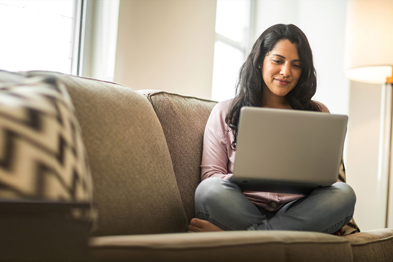 Woman on couch with laptop