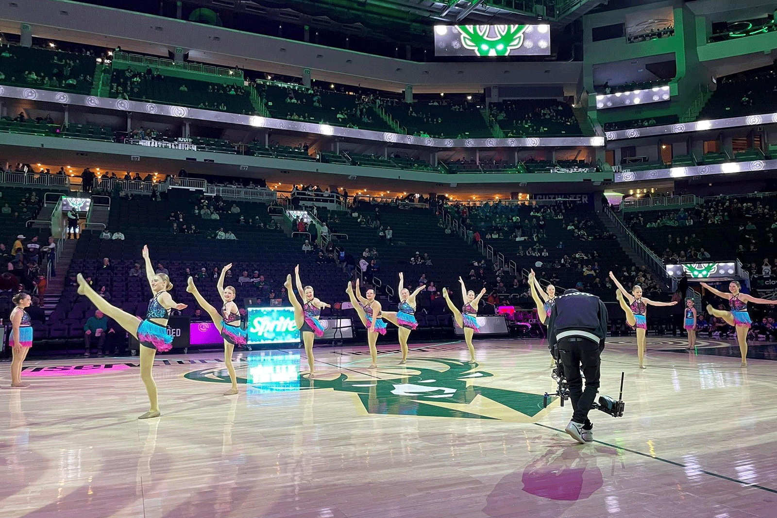 Kenosha’s Step by Step Dance Academy competition team performs under the bright lights at Fiserv Forum