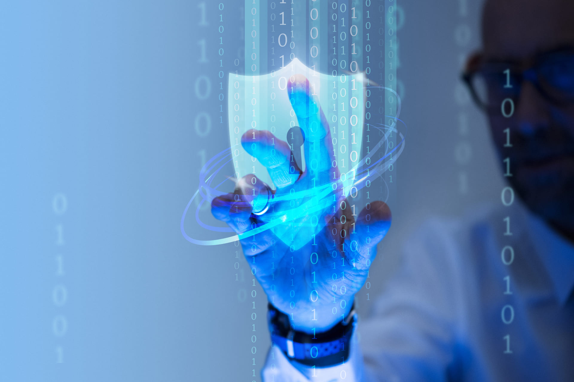 Man-touching-a-digital-security-shield-interface-with-binary-code-overlay - Cyber Insurance