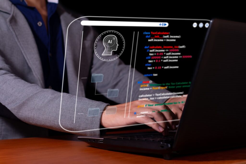 Developer-coding-on-laptop-with-AI-hologram-interface - CMIT Cybersecurity Social Engineering
