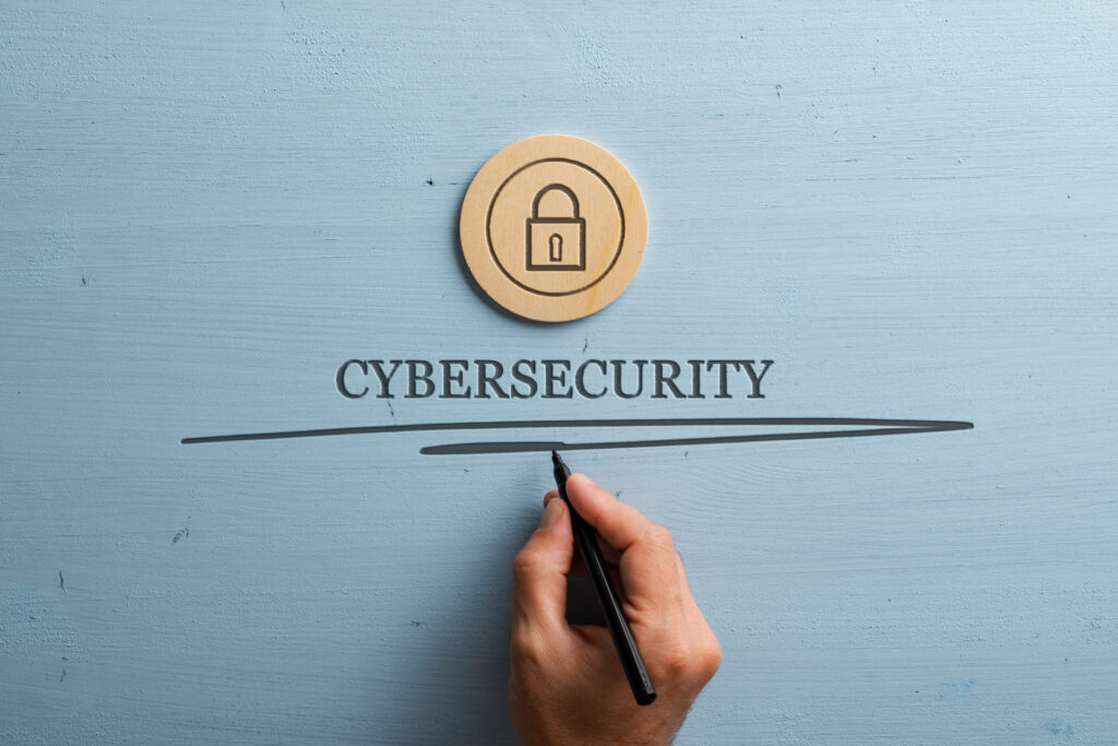 Cyber Security Business guide - Hand-writing-the-word-cybersecurity-with-a-padlock-icon-above-it
