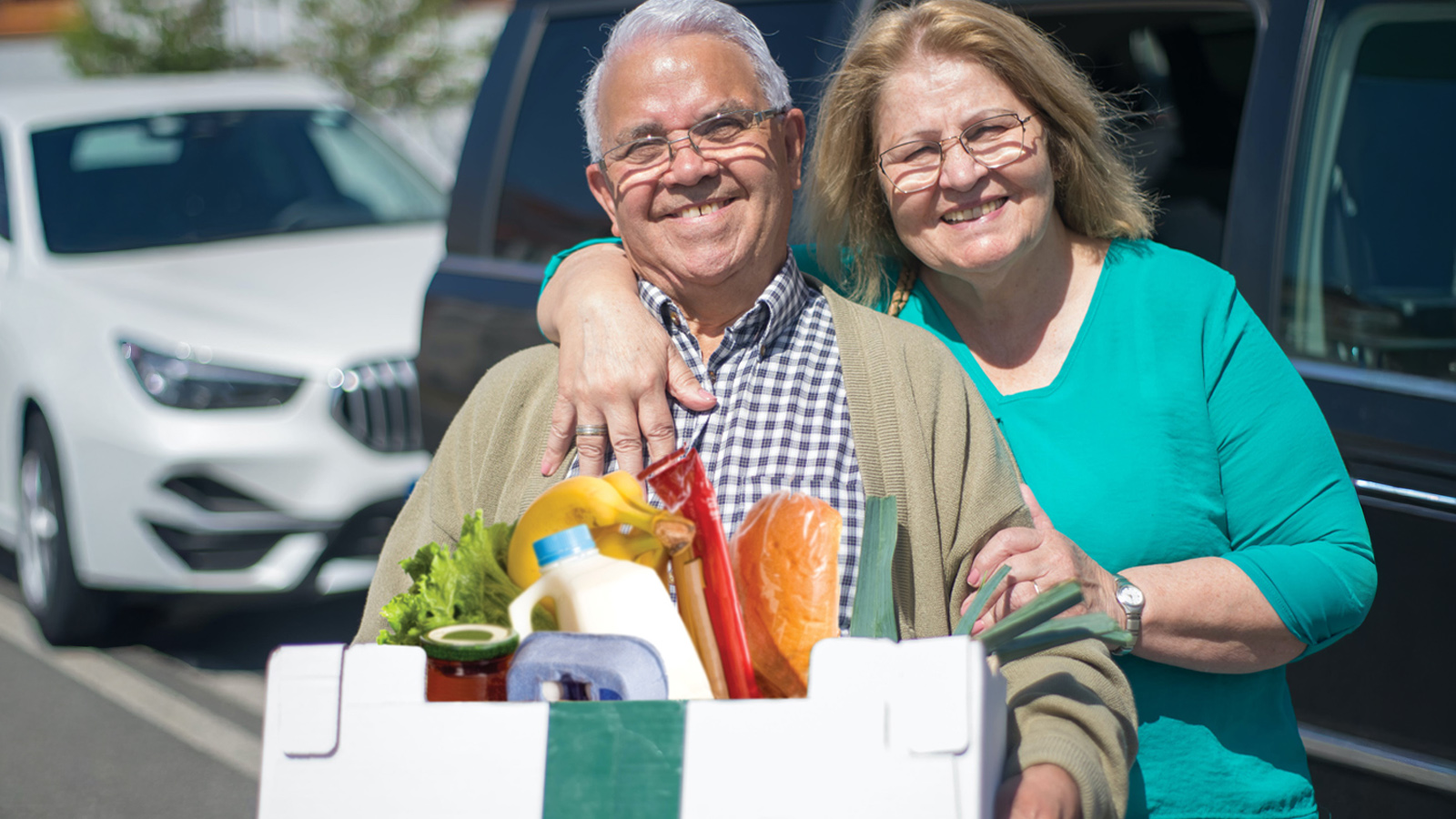 Couple picking up Food Pantry prepared food box - Shalom Center