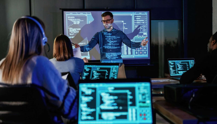 Business-coach-giving-presentation-to-coding-students: Cybersecurity Training for Employees in 8 Steps