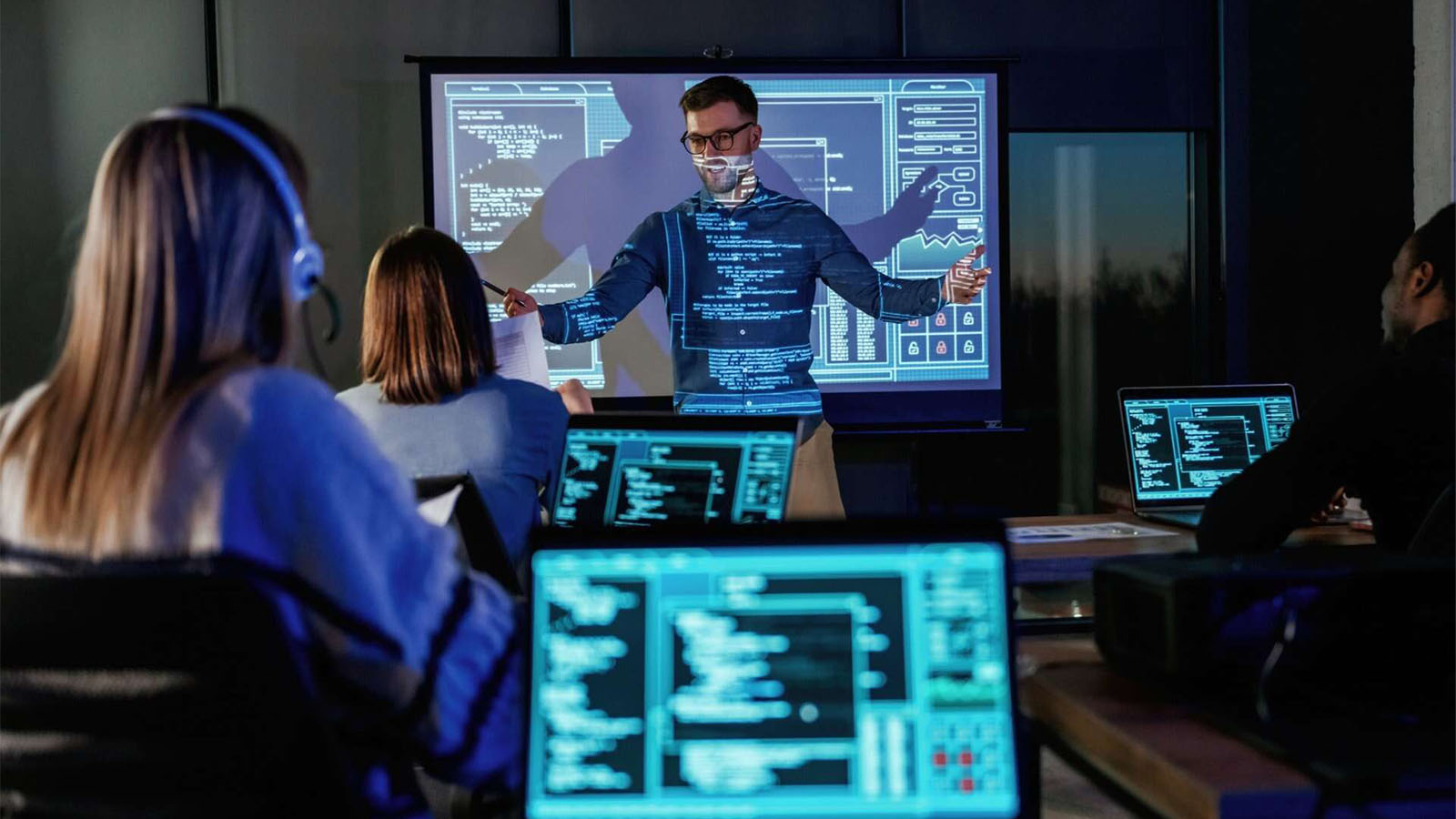 Business-coach-giving-presentation-to-coding-students: Cybersecurity Training for Employees in 8 Steps