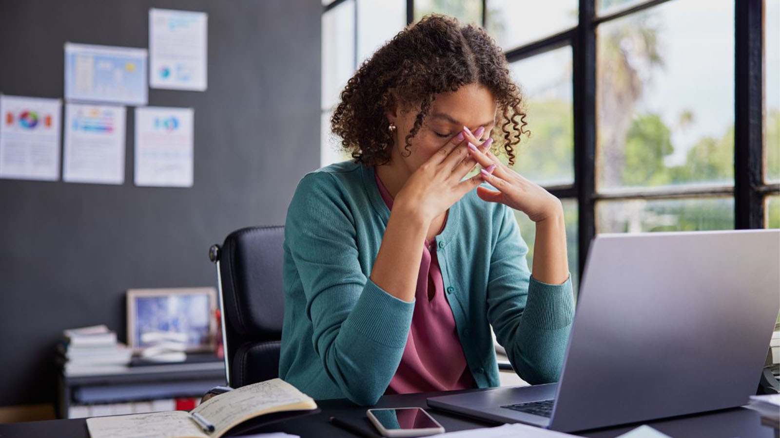Woman sitting in front of laptop - Emerging Cybersecurity Threats Are Hiding in Plain Sight