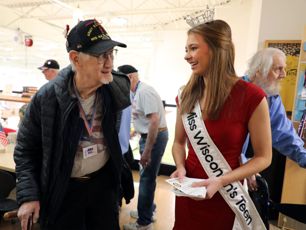 Miss Wisconsin's Teen 2025 Natalie Popp speaks with veteran John Olson during a recent visit to the American Heroes Cafe at Festival Foods in Kenosha.