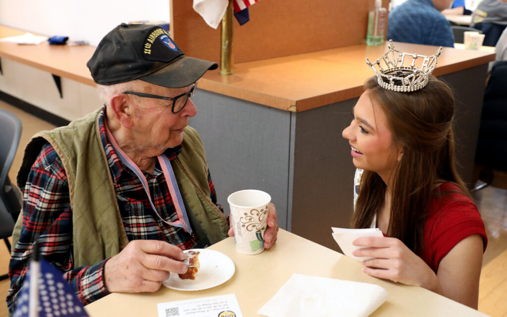 Miss Wisconsin's Teen 2025 Natalie Popp talks with veteran Max North, 99, at the American Heroes Cafe at Festival Foods in Kenosha.